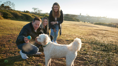 Laurie with his family and their pet dog